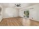 Bright bedroom with wood-look floors, white brick walls, ceiling fan, and glass doors to the outside at 1541 E Cinnabar Ave, Phoenix, AZ 85020