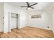 Bright bedroom with wood floors, closet, and natural light at 1541 E Cinnabar Ave, Phoenix, AZ 85020