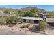 Elevated view of single-story home featuring lovely desert landscaping, carport, and mountain views at 1541 E Cinnabar Ave, Phoenix, AZ 85020