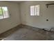 The garage has white walls, two windows, and a utility connection on a cracked cement floor at 1541 E Cinnabar Ave, Phoenix, AZ 85020