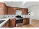 Bright kitchen featuring stainless steel oven and range, white subway tile, and stained wood cabinets at 1541 E Cinnabar Ave, Phoenix, AZ 85020