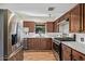 Well-lit kitchen featuring stainless steel appliances, ample counter space, and stylish wood cabinets at 1541 E Cinnabar Ave, Phoenix, AZ 85020