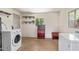Bright laundry area with new appliances, overhead storage and natural light at 1541 E Cinnabar Ave, Phoenix, AZ 85020
