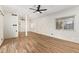 Bright living room boasts wood-look floors, neutral brick walls, a ceiling fan, and two windows at 1541 E Cinnabar Ave, Phoenix, AZ 85020