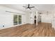 Spacious living room features wood-look floors, neutral brick walls, ceiling fans, and outdoor access at 1541 E Cinnabar Ave, Phoenix, AZ 85020