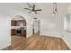 Bright, spacious living room with wood-look floors, ceiling fan, and archway to updated kitchen at 1541 E Cinnabar Ave, Phoenix, AZ 85020