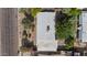 Aerial view shows the flat roof with an AC unit, surrounded by lush landscaping and neighboring properties at 1541 E Cinnabar Ave, Phoenix, AZ 85020