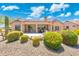 An idyllic backyard featuring low maintenance desert landscaping and covered patio with lots of space to entertain at 15502 W Agua Linda Ln, Surprise, AZ 85374