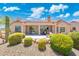 The backyard features low maintenance desert landscaping and a large covered patio for entertaining at 15502 W Agua Linda Ln, Surprise, AZ 85374