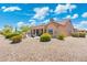 The backyard features a covered patio, desert landscaping, and a private space to relax and unwind at 15502 W Agua Linda Ln, Surprise, AZ 85374