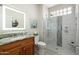 Modern bathroom featuring a walk-in shower with marble tile and a granite vanity at 15502 W Agua Linda Ln, Surprise, AZ 85374