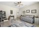 Neutral bedroom offers a daybed, ceiling fan, and a desk, providing comfort and functionality at 15502 W Agua Linda Ln, Surprise, AZ 85374