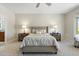 Spacious primary bedroom featuring a ceiling fan, ensuite bath and plush carpet at 15502 W Agua Linda Ln, Surprise, AZ 85374