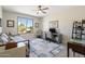Bright bedroom features a window with outdoor views, daybed, and a desk/office area at 15502 W Agua Linda Ln, Surprise, AZ 85374