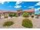 Charming single-story home featuring desert landscaping, a red tile roof, and manicured shrubs at 15502 W Agua Linda Ln, Surprise, AZ 85374