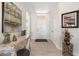 Welcoming foyer with neutral tile flooring, white walls, and an ornate console table at 15502 W Agua Linda Ln, Surprise, AZ 85374
