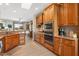 Well-equipped kitchen with custom wood cabinets, stainless steel appliances, and granite countertops at 15502 W Agua Linda Ln, Surprise, AZ 85374