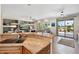 Open-concept kitchen with granite countertop, sink, and views of the living room and backyard at 15502 W Agua Linda Ln, Surprise, AZ 85374