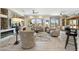 Open-concept living area showcasing hardwood floors, golf course views, and a wet bar at 15502 W Agua Linda Ln, Surprise, AZ 85374