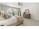 Comfortable main bedroom featuring a bay window with desert views and a neutral decor palette at 15502 W Agua Linda Ln, Surprise, AZ 85374