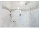 Tiled walk-in shower with bench, niche, and glass block window at 15502 W Agua Linda Ln, Surprise, AZ 85374