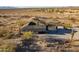 Desert home showcasing a rustic landscape with mature cacti and shrubs, as well as views of the surrounding desert environment at 15612 S Tuthill Rd, Buckeye, AZ 85326