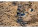 Aerial view of a house set in a arid landscape with some trees and native plants at 15612 S Tuthill Rd, Buckeye, AZ 85326