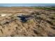 Aerial view of the single story home with a view of the desert landscape at 15612 S Tuthill Rd, Buckeye, AZ 85326