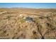 Desert home with a white shed and natural desert landscaping in the surrounding area at 15612 S Tuthill Rd, Buckeye, AZ 85326