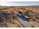 Aerial view of the single story desert home with a large driveway and desert landscape at 15612 S Tuthill Rd, Buckeye, AZ 85326