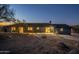 Inviting backyard view of the home featuring large windows and desert landscaping at 15612 S Tuthill Rd, Buckeye, AZ 85326