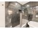 Detailed view of the sleek black marble tiled shower and modern fixtures in the bathroom at 15612 S Tuthill Rd, Buckeye, AZ 85326