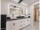 Modern bathroom featuring double vanity, illuminated mirror, and sleek fixtures at 15612 S Tuthill Rd, Buckeye, AZ 85326