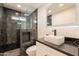 Bathroom featuring a walk-in shower, sleek vanity, and modern fixtures at 15612 S Tuthill Rd, Buckeye, AZ 85326