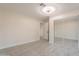 Neutral bedroom boasts tile floors and mirrored closet doors, offering a spacious and modern feel at 15612 S Tuthill Rd, Buckeye, AZ 85326