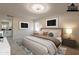 Serene bedroom showcases contemporary decor with a king-sized bed, neutral tones, and stylish artwork at 15612 S Tuthill Rd, Buckeye, AZ 85326