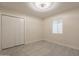 Bright bedroom with neutral walls and tile flooring at 15612 S Tuthill Rd, Buckeye, AZ 85326