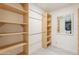 Spacious walk-in closet with built-in shelving and hanging rods at 15612 S Tuthill Rd, Buckeye, AZ 85326