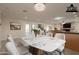 Bright dining area with modern table and chairs, seamlessly connecting with kitchen and offering a comfortable space at 15612 S Tuthill Rd, Buckeye, AZ 85326