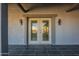 Covered entrance featuring French doors, textured stucco and gray trim at 15612 S Tuthill Rd, Buckeye, AZ 85326