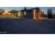 Single-story home exterior featuring garage, gravel driveway and manicured desert plants at 15612 S Tuthill Rd, Buckeye, AZ 85326