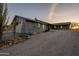 Charming home featuring a gravel driveway, native trees, and desert landscaping at 15612 S Tuthill Rd, Buckeye, AZ 85326