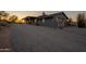 Charming home featuring a gravel driveway, native trees, and desert landscaping at 15612 S Tuthill Rd, Buckeye, AZ 85326