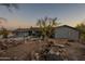 Charming home featuring a well-maintained yard with mature trees and desert landscaping at 15612 S Tuthill Rd, Buckeye, AZ 85326