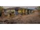 Beautiful single-story home featuring a covered deck in a serene desert landscape at 15612 S Tuthill Rd, Buckeye, AZ 85326