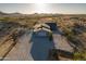 Aerial view of the home, gravel driveway, and natural desert landscaping at 15612 S Tuthill Rd, Buckeye, AZ 85326