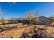 Charming gray single-story home with desert landscaping and clear blue skies at 15612 S Tuthill Rd, Buckeye, AZ 85326