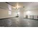 A spacious garage featuring laundry hookups, a sink, and ample room for storage and projects at 15612 S Tuthill Rd, Buckeye, AZ 85326