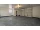 Spacious garage with an open door, featuring ample space and a practical design at 15612 S Tuthill Rd, Buckeye, AZ 85326