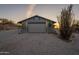 Charming detached garage featuring a gravel driveway, native trees, and desert landscaping at 15612 S Tuthill Rd, Buckeye, AZ 85326